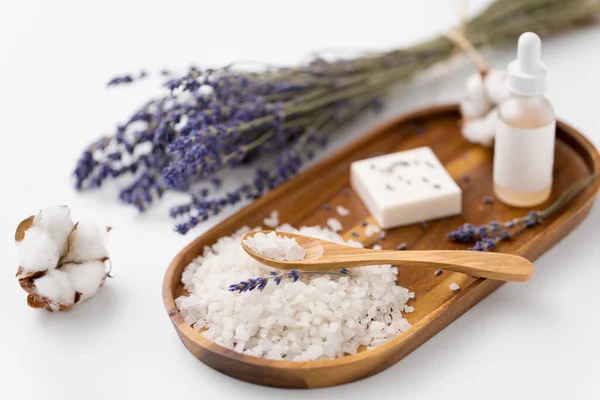 Sea salt, lavender soap and serum on wooden tray — Stock Photo, Image