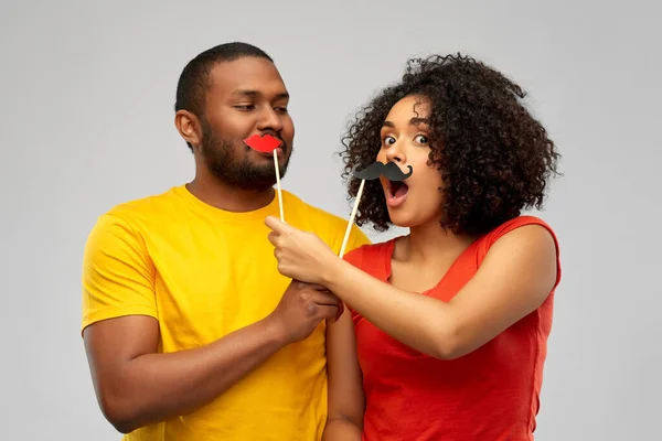 Happy african american couple with party props — Stock Photo, Image