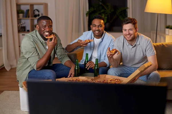 Amici maschi felici con birra mangiare pizza a casa — Foto Stock