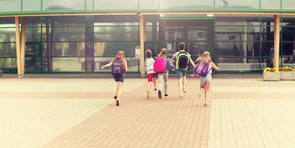 Group of happy elementary school students running — Stock Photo, Image