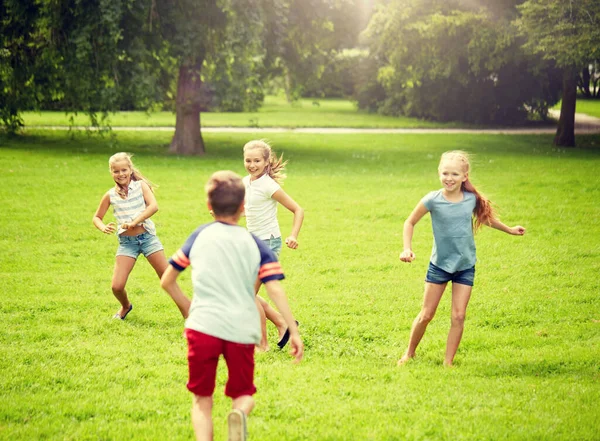 Happy kids running and playing game outdoors Stock Image