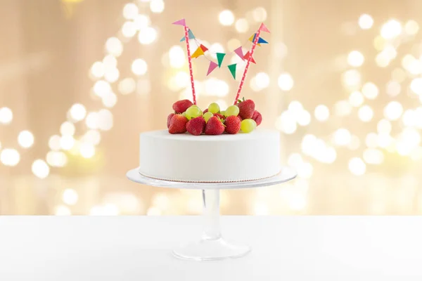 Primer plano de pastel de cumpleaños con guirnalda en el stand — Foto de Stock