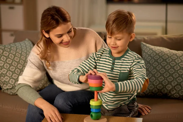 Mother and son playing with toy pyramid at home — Stok fotoğraf