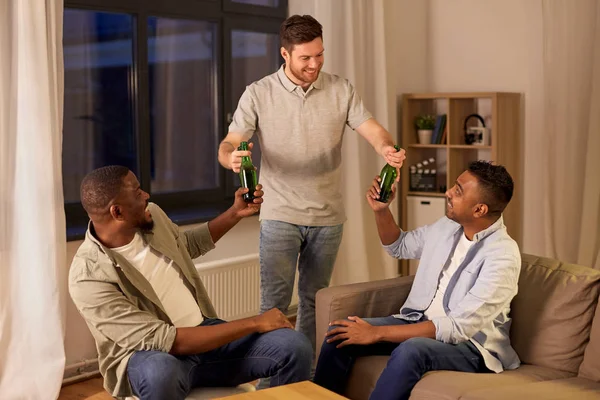 Amici maschi felici bere birra a casa di notte — Foto Stock