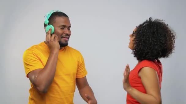 African american couple with headphones dancing — 비디오