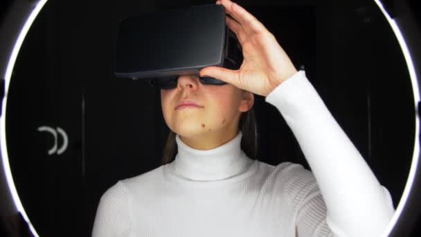 Woman in virtual reality headset or vr glasses — Stockvideo