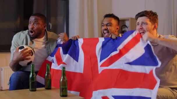 Friends with british flag watching soccer at home — Stock Video