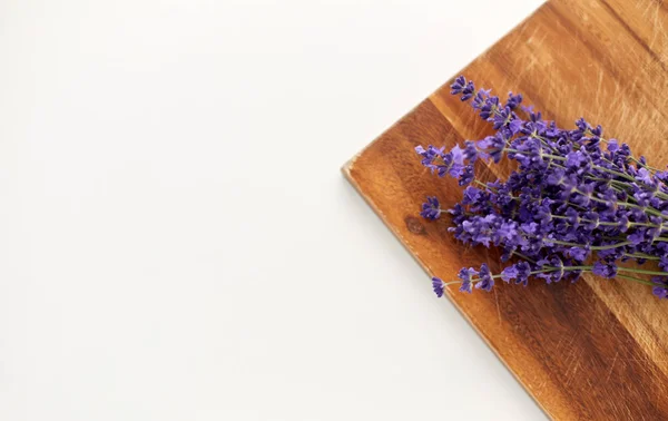 Bunch of lavender flowers on wooden board — Stock Photo, Image