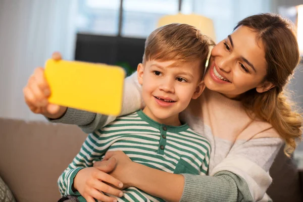 Mor och son tar selfie via smartphone hemma — Stockfoto