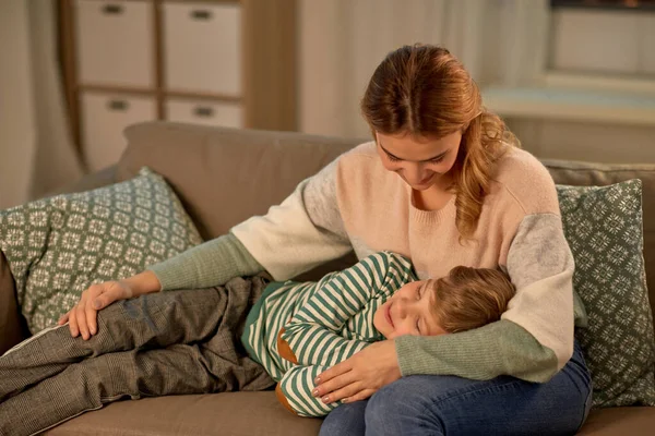 Happy mother with sleeping little son at home — Stock Photo, Image