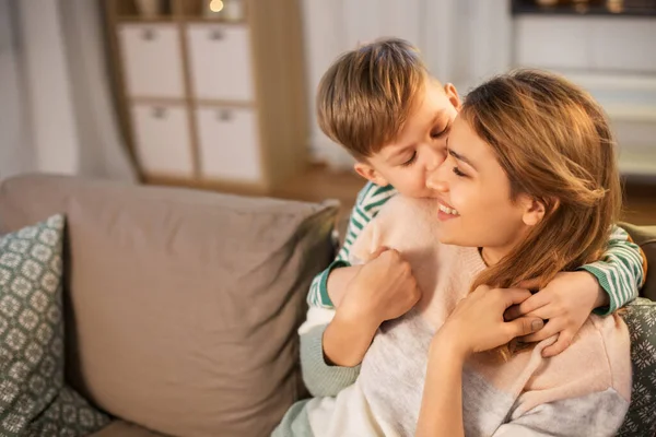 Happy smiling mother and son hugging at home — ストック写真