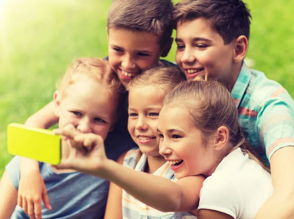 Szczęśliwe dzieci lub przyjaciół, biorąc selfie w lato park — Zdjęcie stockowe