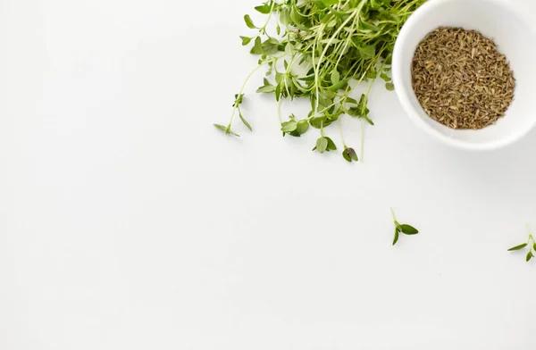 Fresh thyme and dry seasoning on white background — ストック写真