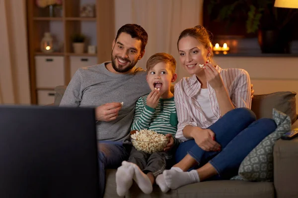 Família feliz com pipocas assistindo tv em casa — Fotografia de Stock