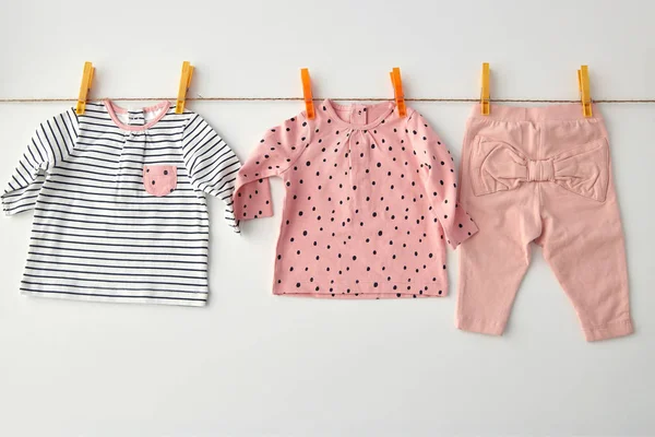 Shirts and pants for baby girl on clothesline — Stockfoto