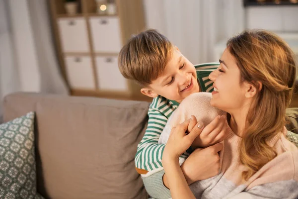 Happy smiling mother and son hugging at home — ストック写真