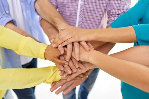 Group of students stacking hands — Stockfoto