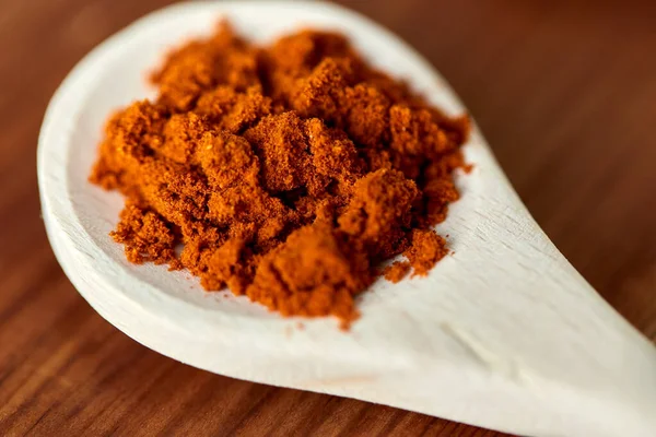Close up of turmeric on wooden spoon — Stock Photo, Image