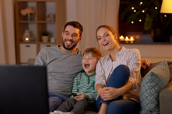 Счастливая семья смотрит телевизор дома по ночам — стоковое фото