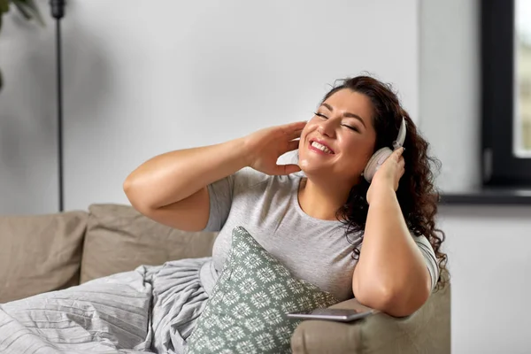 Femme dans les écouteurs écouter de la musique à la maison — Photo