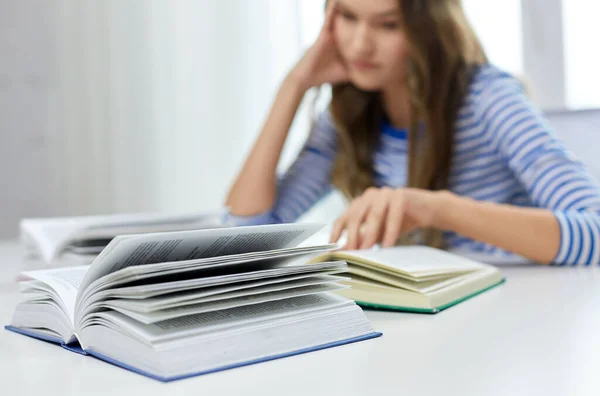 Close up of student girl reading books at home — Stock Photo, Image