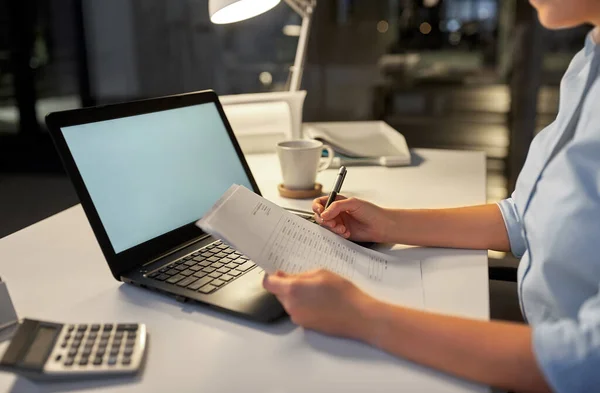 Affärskvinna med papper som arbetar på natten kontor — Stockfoto