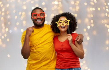 happy african american couple with party props clipart