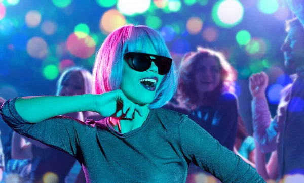 Mujer en peluca rosa y gafas de sol bailando en la fiesta — Foto de Stock