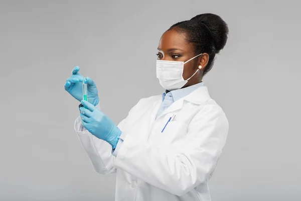 Mujer afroamericana doctora con jeringa —  Fotos de Stock
