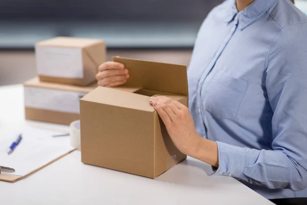 Femme emballage boîte de colis au bureau de poste — Photo