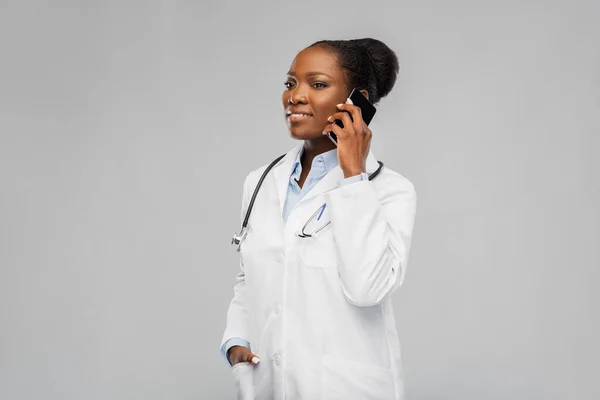 Африканская женщина-врач звонит на смартфон — стоковое фото