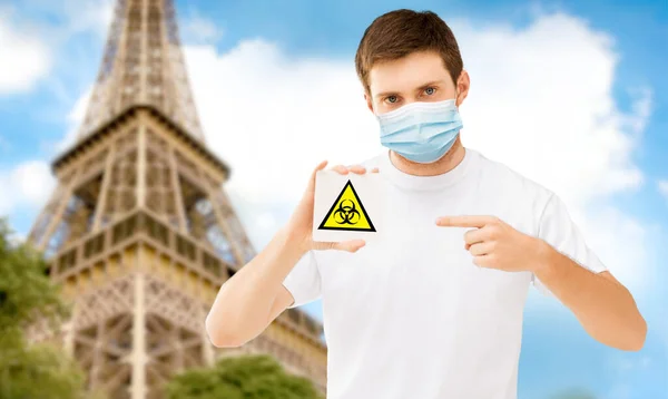 Man in mask with biohazard sign in france — Stockfoto