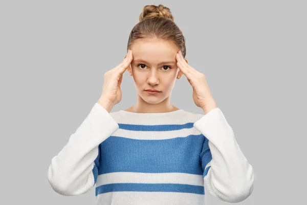 Teenage girl having headache over grey background — Zdjęcie stockowe