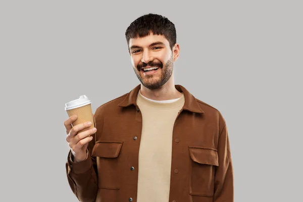 Sonriente joven con taza de café para llevar —  Fotos de Stock