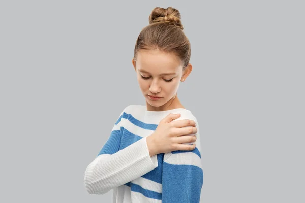 Teenage girl having pain in shoulder — Stock Photo, Image