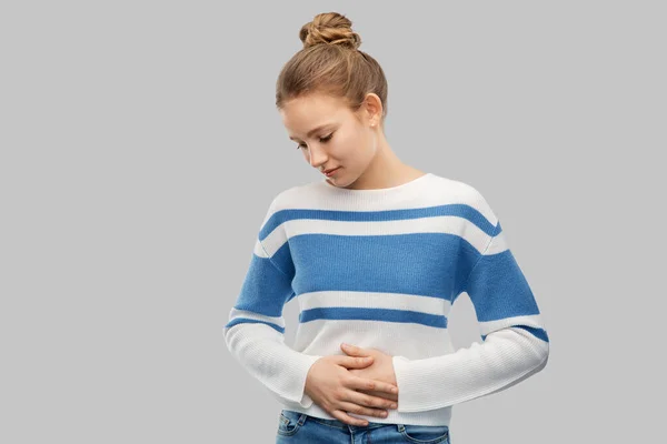 Teenage girl having stomach ache — Stock Photo, Image