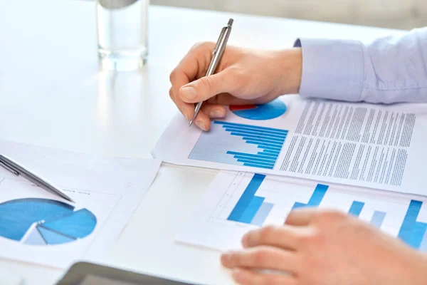 Close up of businessmans hands with charts — Stock Photo, Image