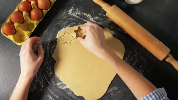 Hands cutting dough with star shaped cutter — Stock Video