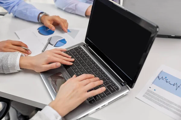 Close up of businesspeople with laptop at office — Stock Photo, Image