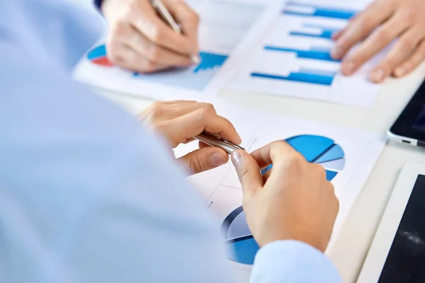 Close up of businessmans hands with charts — Stock Photo, Image