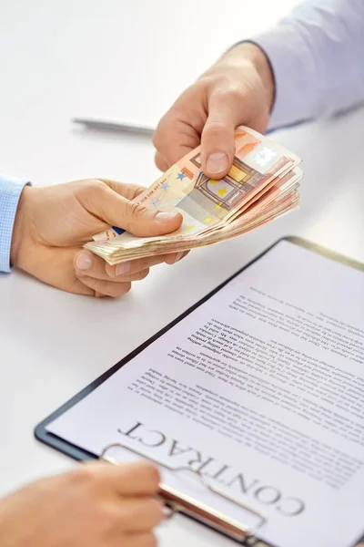 Close up of hands with euro money and contract — Stock Photo, Image