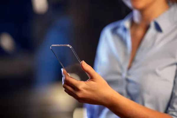 Close up of hand with transparent smartphone — Stock Photo, Image