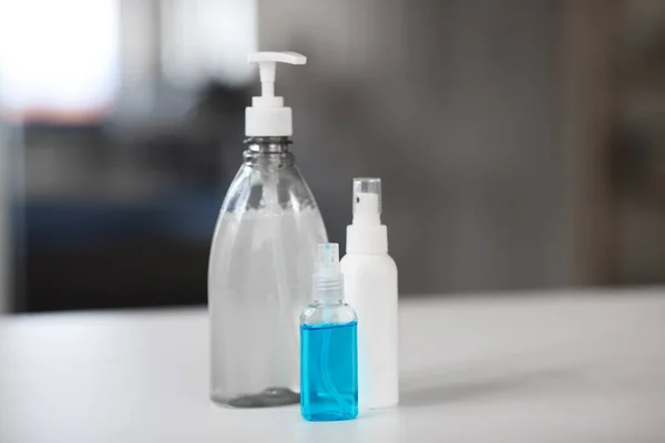 Close up of different hand sanitizers on table — Stock Photo, Image