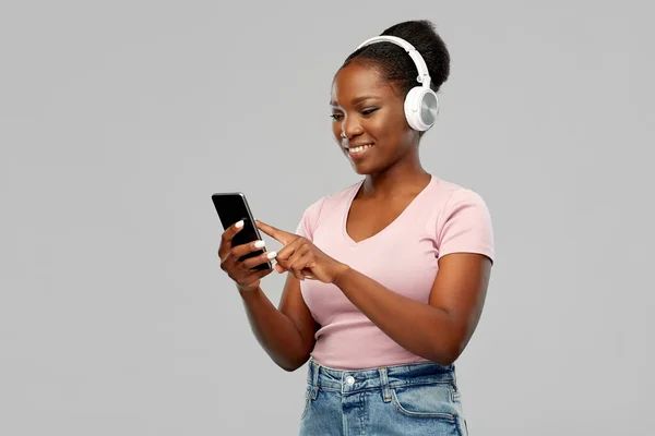 African woman in headphones listening to music — Stock Photo, Image