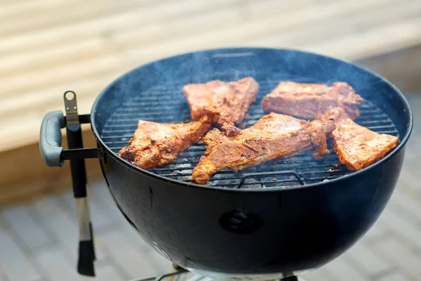 Close up of barbecue meat roasting on grill — Stock Photo, Image