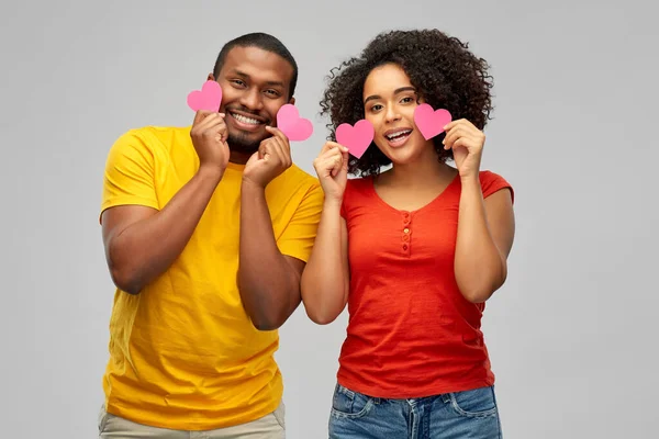 happy african american couple with hearts