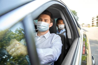 taxi driver in face protective mask driving car clipart