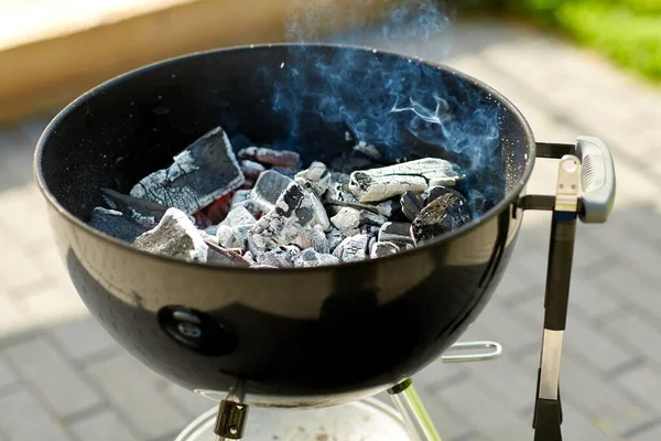 Charcoal smoldering in brazier outdoors — Stock Photo, Image