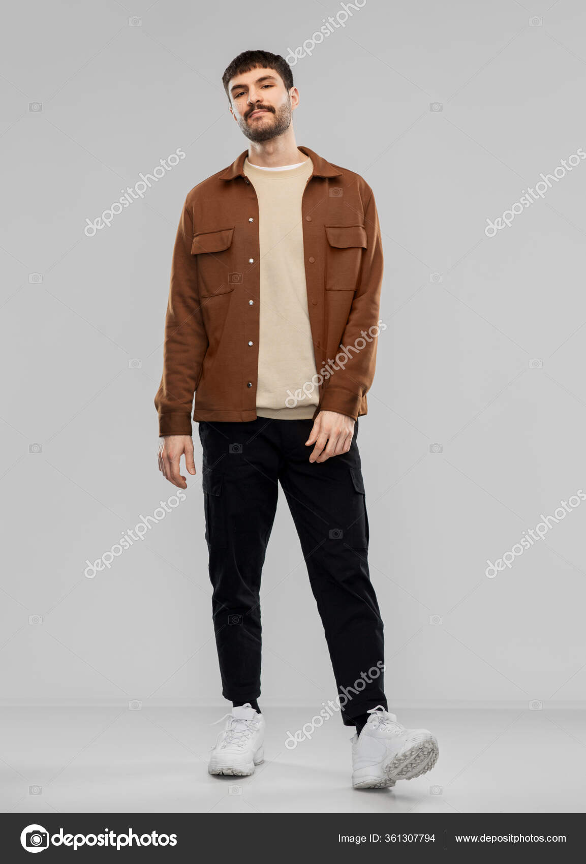 Young man in brown jacket and black pants — Stock Photo