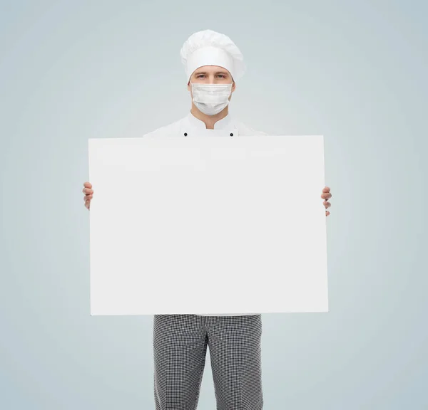 Male chef in face mask with white billboard — Stock Photo, Image